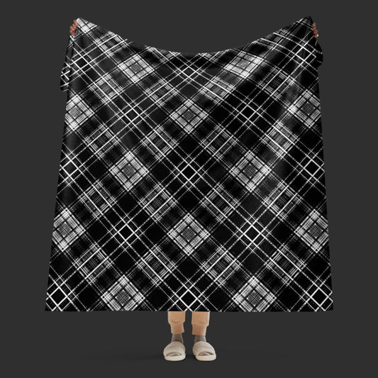 Large fleece sherpa blanket with a fuzzy distressed plaid pattern in black and white.