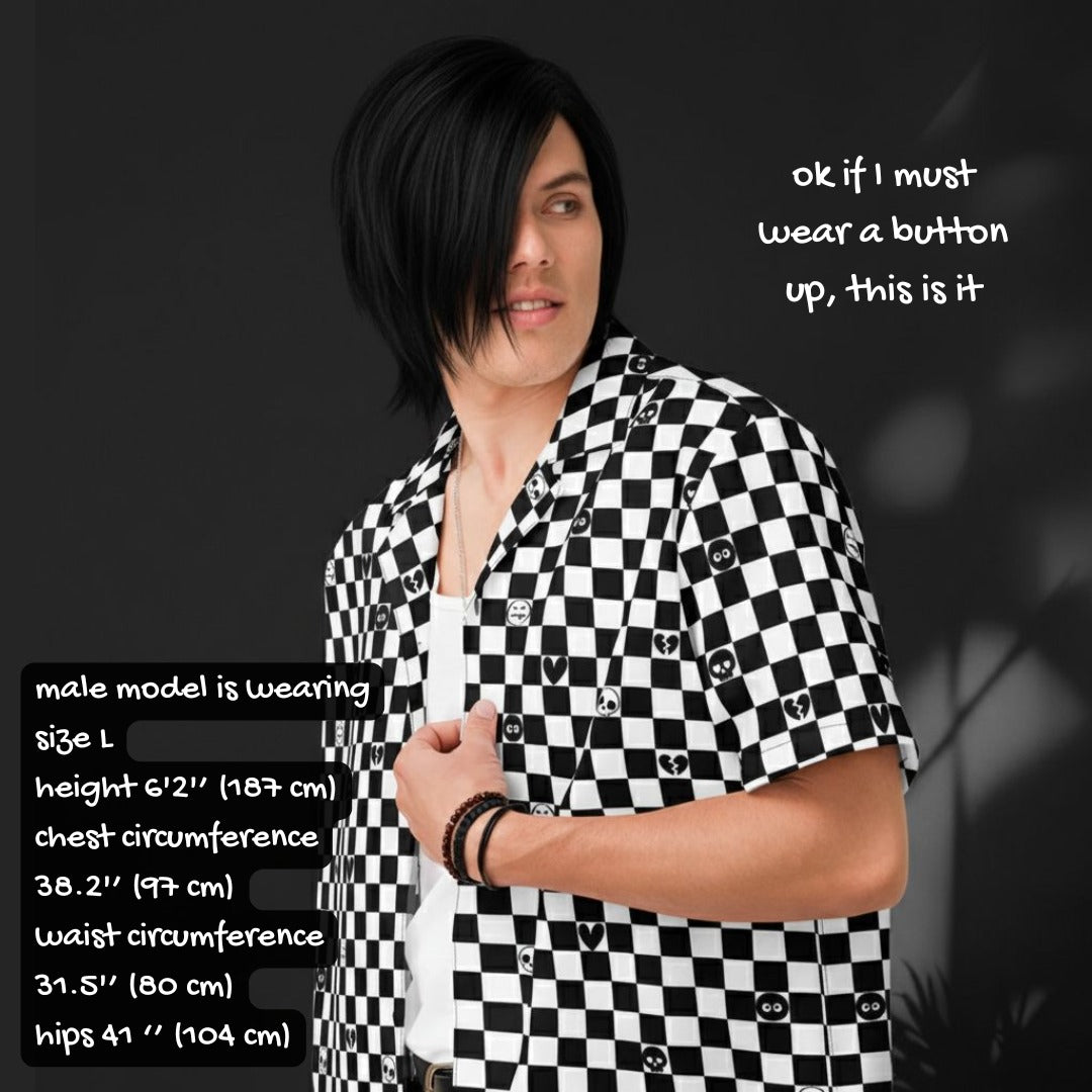 Person wearing a black and white checkered button up shirt with emo symbols