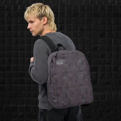 Man carrying a blue grey broken skewed mosaic pattern backpack