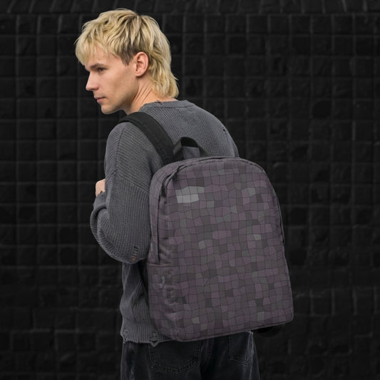 Man carrying a blue grey broken skewed mosaic pattern backpack