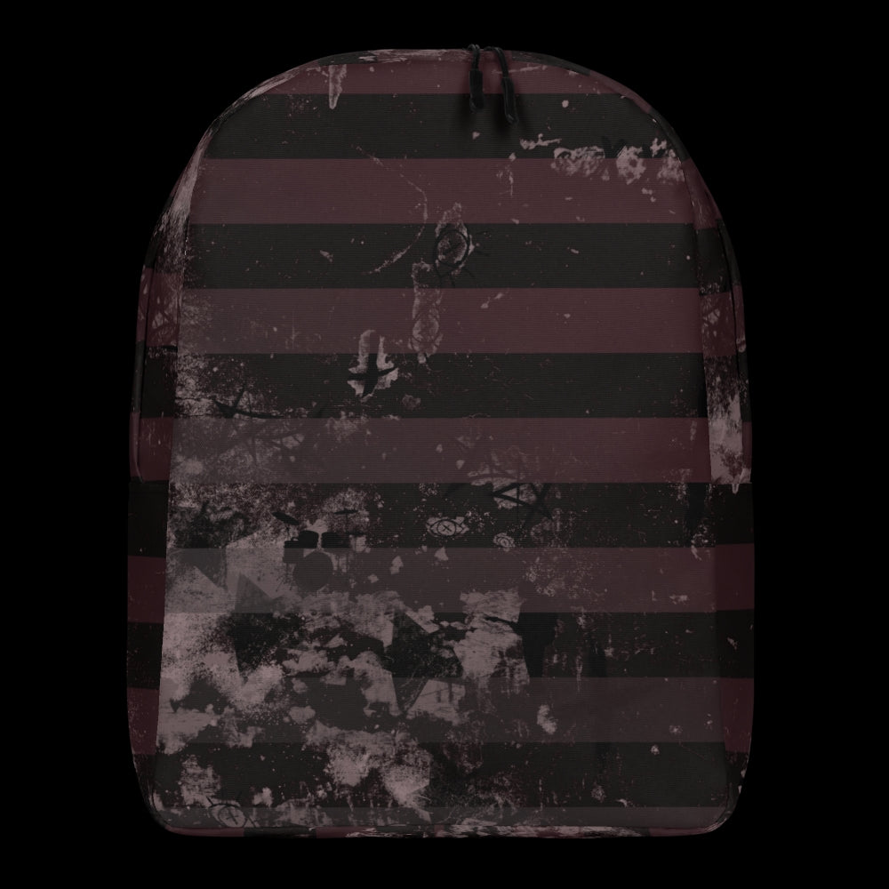 a grunge striped backpack in deep burgundy red and black, with a grungy collage that's visible close-up. 