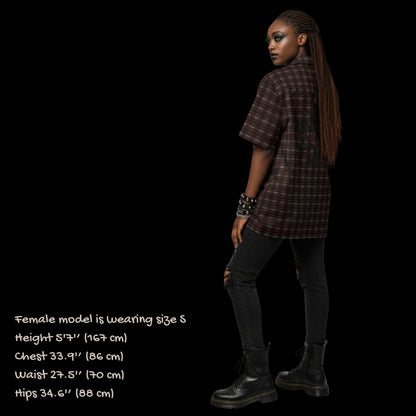 Alt style person wearing a dark punk tartan pattern short sleeve shirt with back print Punks not dead.