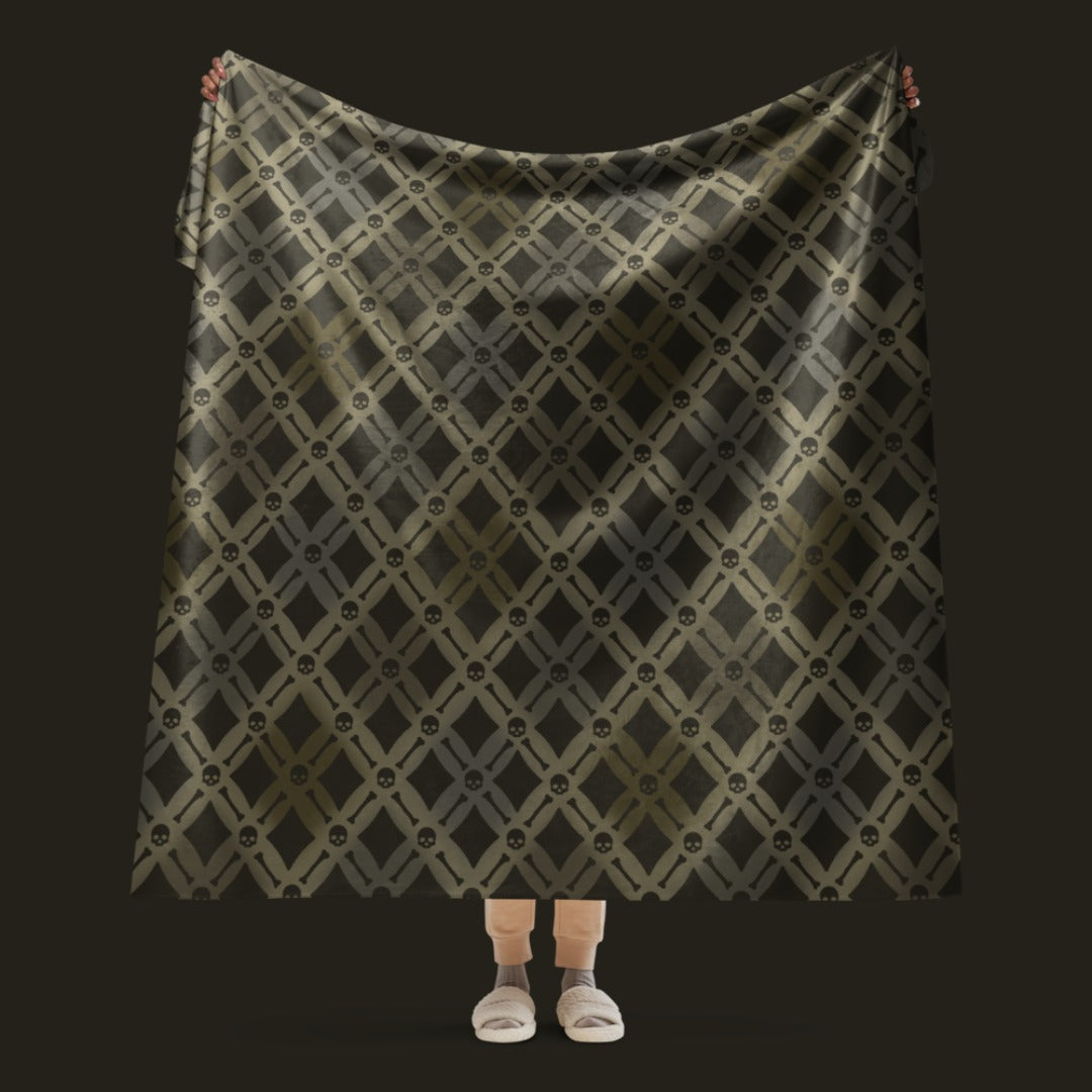 A fleece sherpa blanket with a soft argyle pattern and skulls and bones diagonals