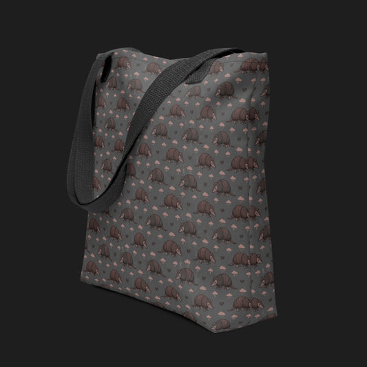 tote bag with an emo armadillo pattern with broken hearts and storm clouds in dusty pink and grey