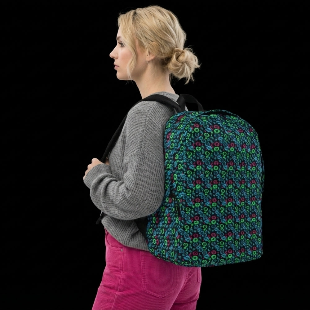Person carrying a backpack with an alt emo skull candy pattern in teal pink and green