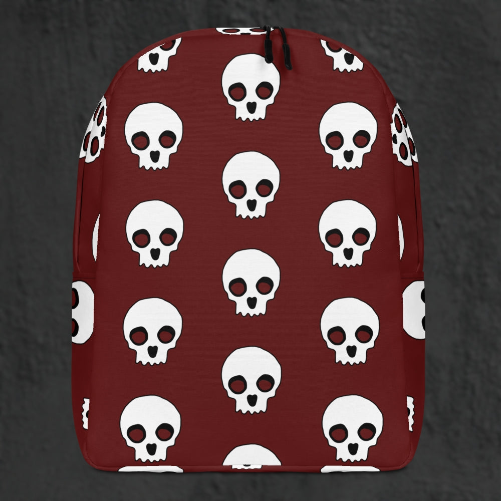 a backpack with a large skull pattern on deep red