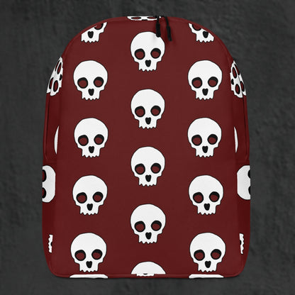 a backpack with a large skull pattern on deep red