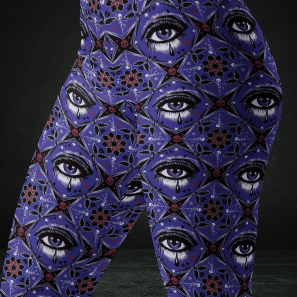 Blue kaleidoscope like leggings with crying eyes and emo symbols
