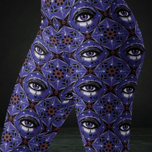 Blue kaleidoscope like leggings with crying eyes and emo symbols