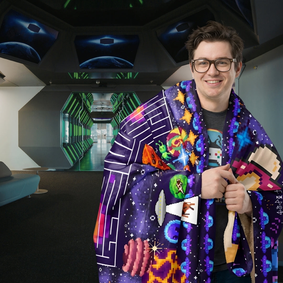 Person in a space craft looking  room wrapped in a huge sherpa blanket with pixel art puzzles and space theme