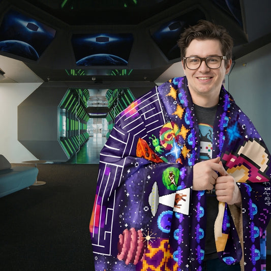 Person in a space craft looking  room wrapped in a huge sherpa blanket with pixel art puzzles and space theme