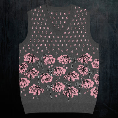 a charcoal knitted vest with crying pink flowers and droplets