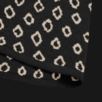 A black short sleeve knit featuring a line art skull with headphones and hand drawn diamonds