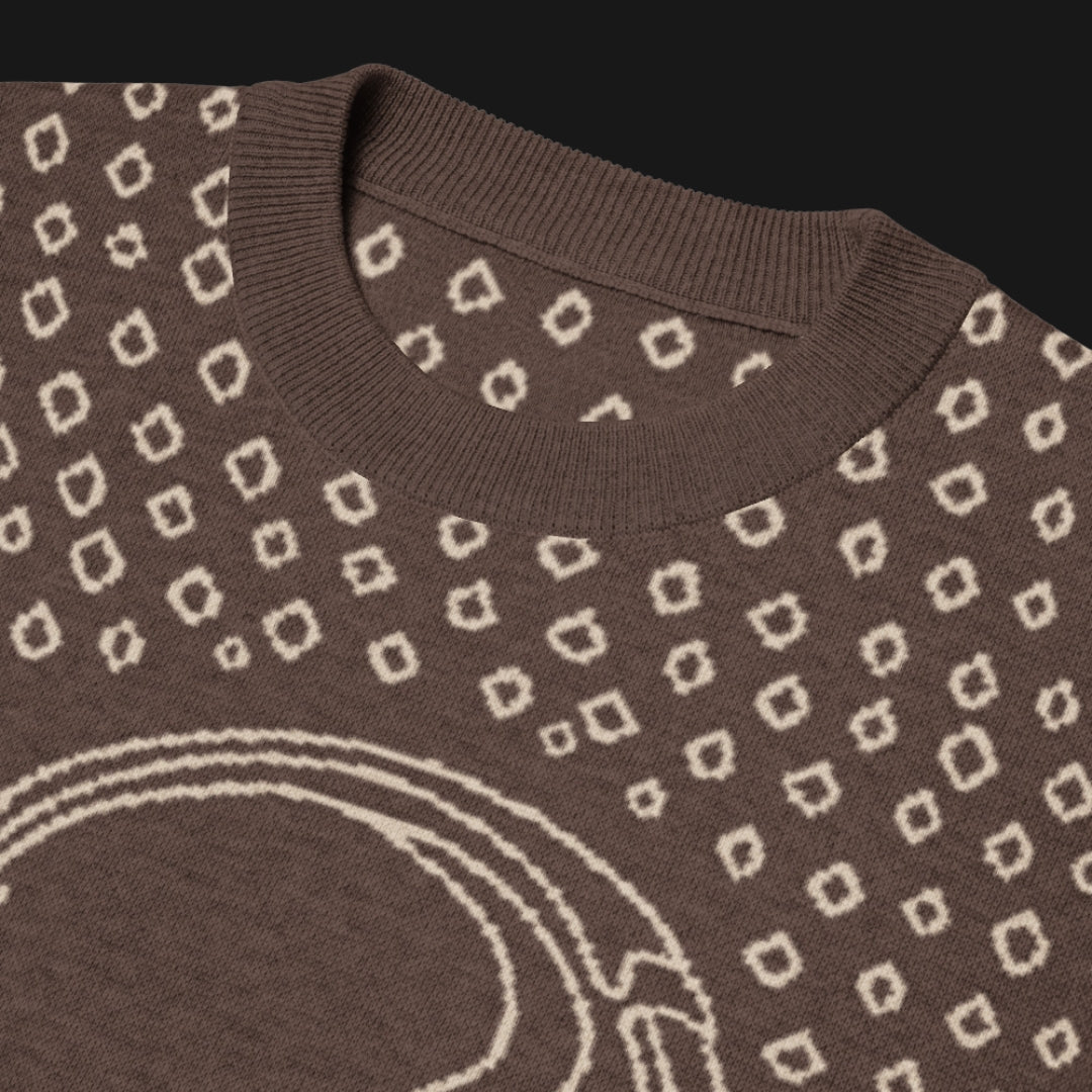 A brown short sleeve knit featuring a line art skull with headphones and hand drawn diamonds