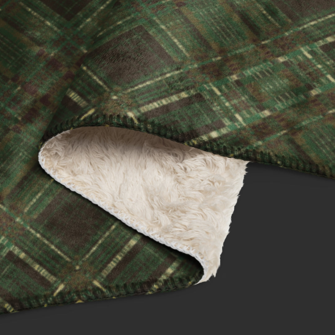 A large fleece sherpa blanket with a distressed plaid pattern in forest witchy shades