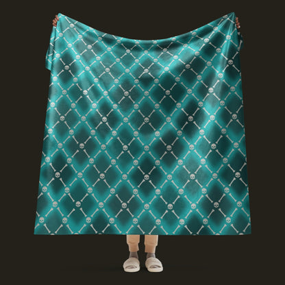 A fleece sherpa blanket with a soft argyle pattern and skulls and bones diagonals