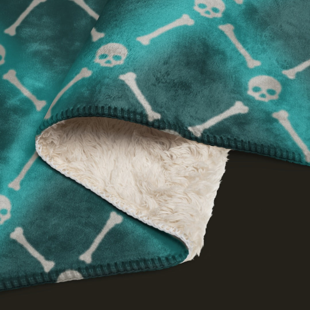 A fleece sherpa blanket with a soft argyle pattern and skulls and bones diagonals