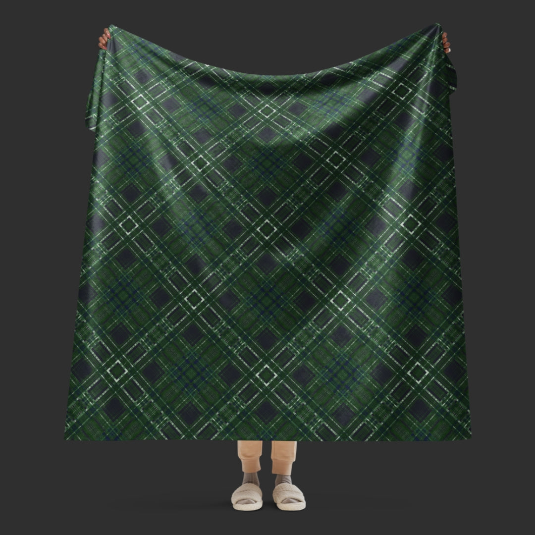 A large fleece sherpa blanket with a distressed plaid pattern in forest witchy shades