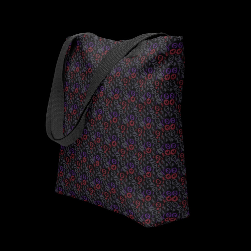 A tote bag with a skull candy pattern in dark grey, purple and red