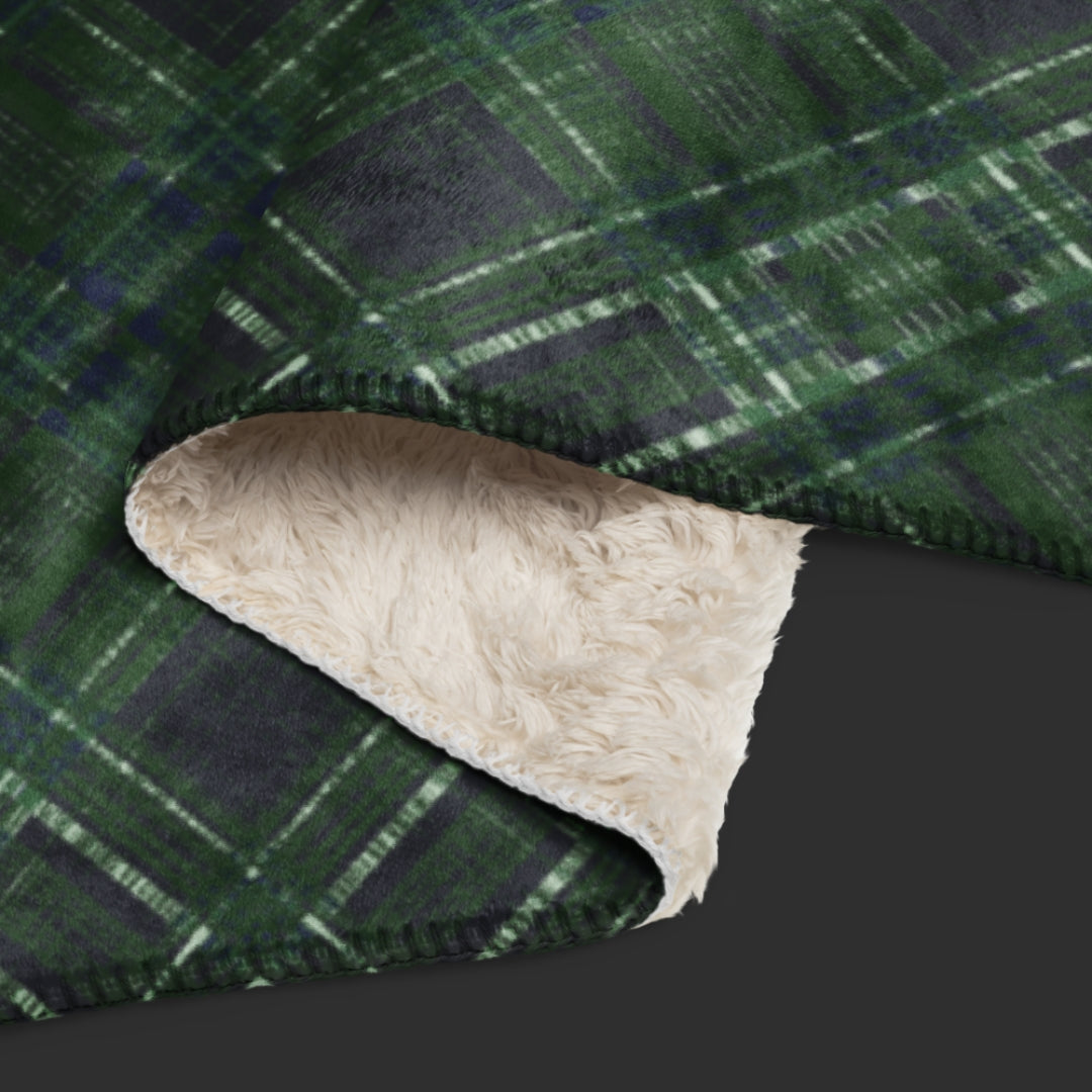 A large fleece sherpa blanket with a distressed plaid pattern in forest witchy shades