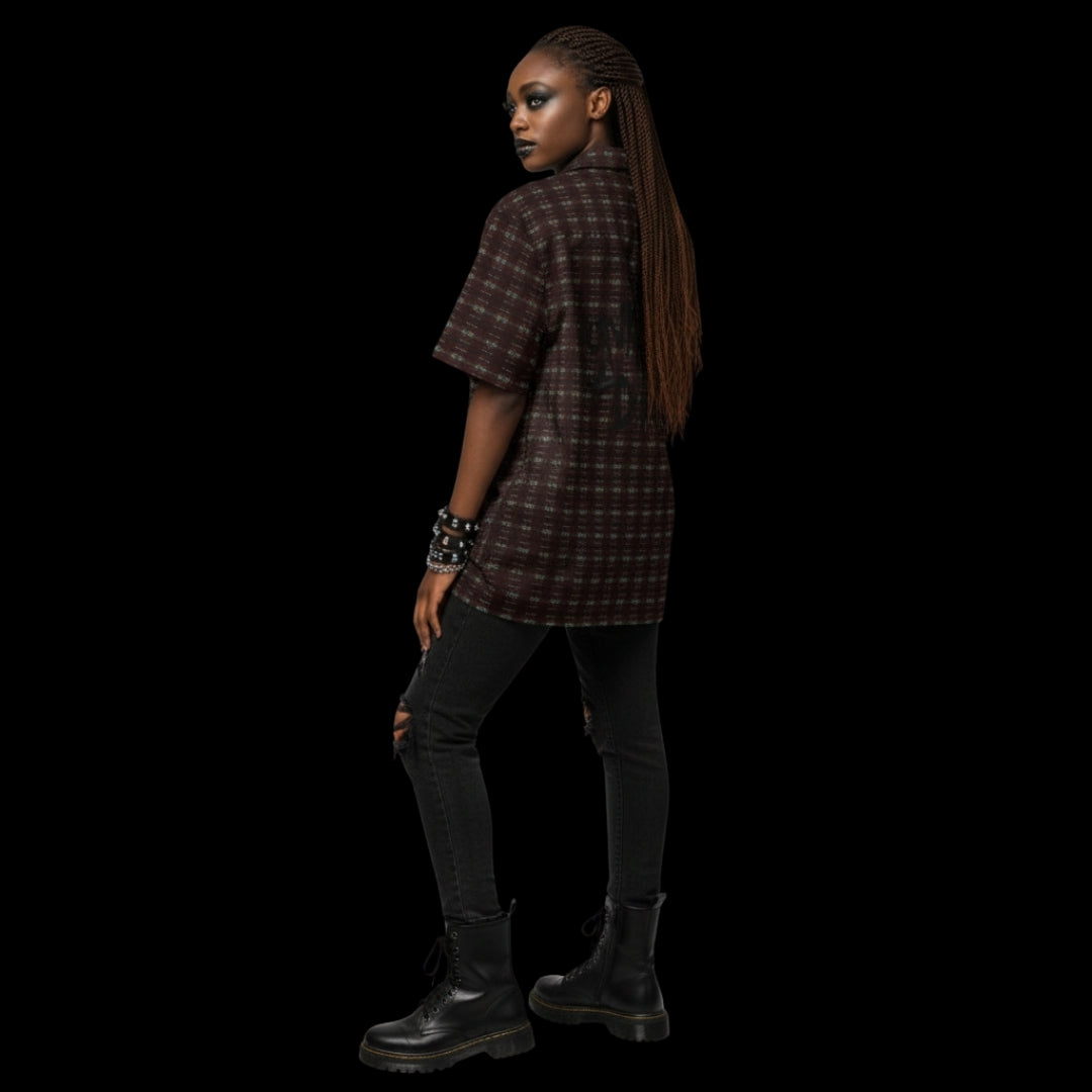 Alt style person wearing a dark punk tartan pattern short sleeve shirt with back print Punks not dead.