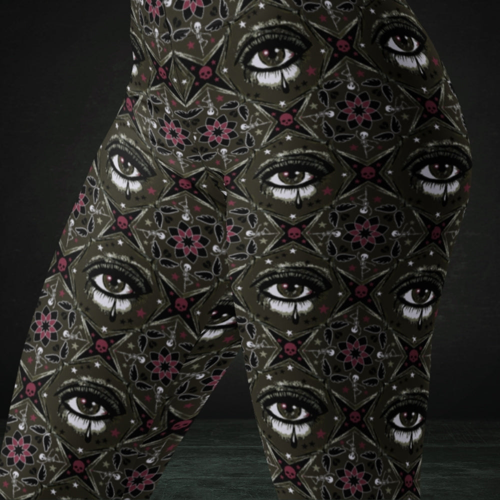 Brown kaleidoscope like leggings with crying eyes and emo symbols