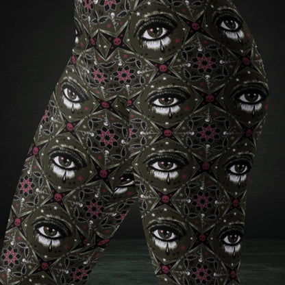 Brown kaleidoscope like leggings with crying eyes and emo symbols