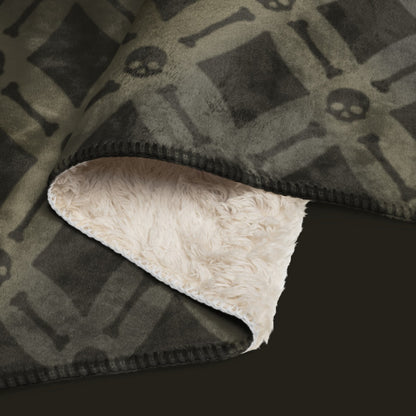 A fleece sherpa blanket with a soft argyle pattern and skulls and bones diagonals