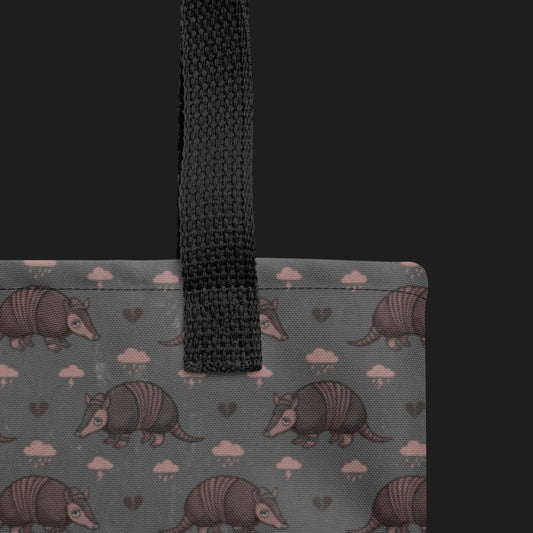tote bag with an emo armadillo pattern with broken hearts and storm clouds in dusty pink and grey