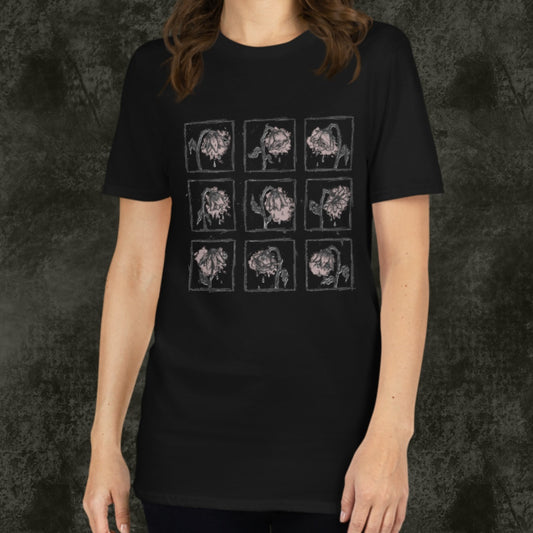 Person wearing a black gildan 64000 tee with a grid of sad crying flowers in soft pink