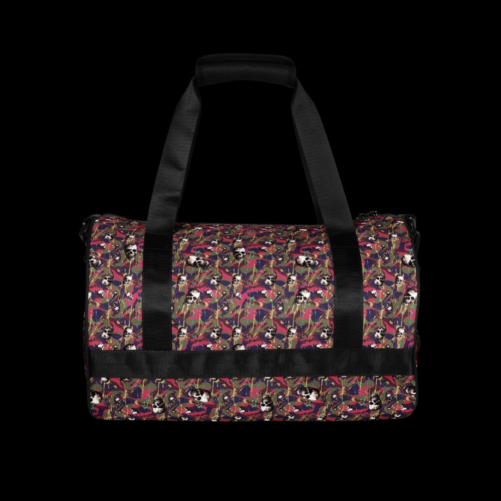 a duffel gym bag with a camo, paint splatter, and gritty skulls pattern in pink and purple shades