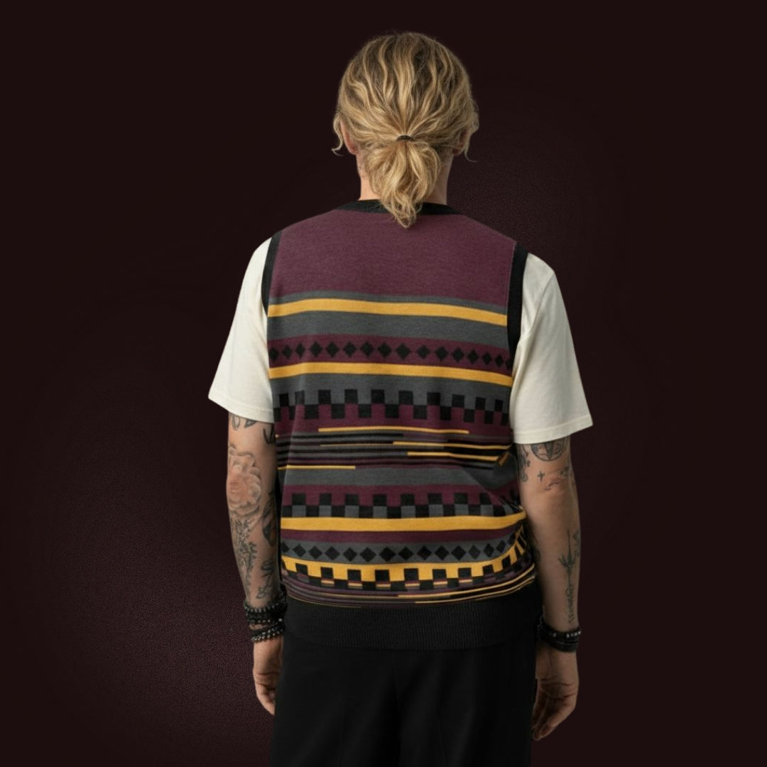 Person wearing an alt style knitted vest with an irregular unexpected pattern and cool color combination