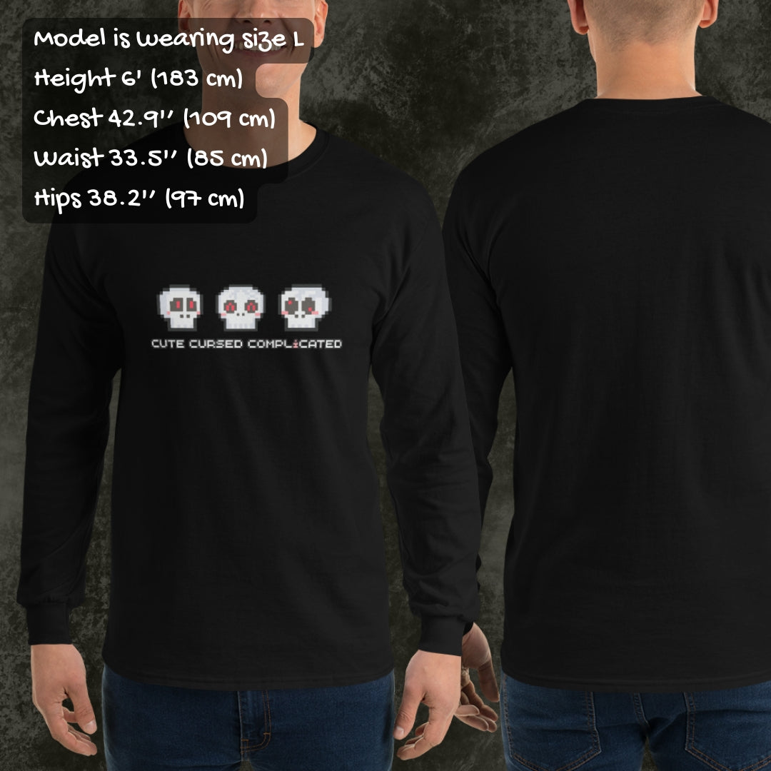 Person wearing a long sleeve tee with pixel art cute skulls and text "cute cursed complicated"