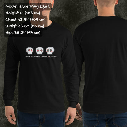 Person wearing a long sleeve tee with pixel art cute skulls and text "cute cursed complicated"