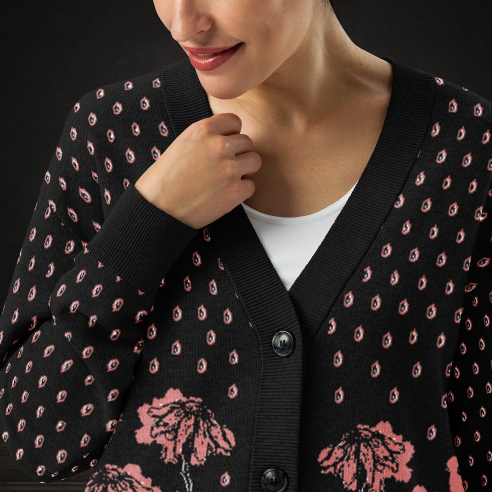 Person wearing an emotional black knitted cardigan with tears and crying flowers