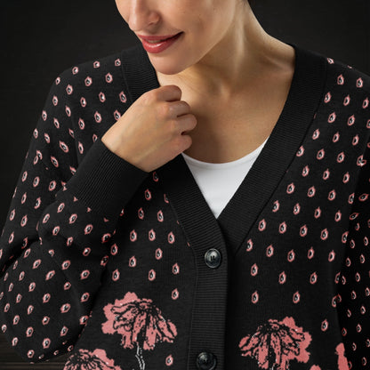 Person wearing an emotional black knitted cardigan with tears and crying flowers