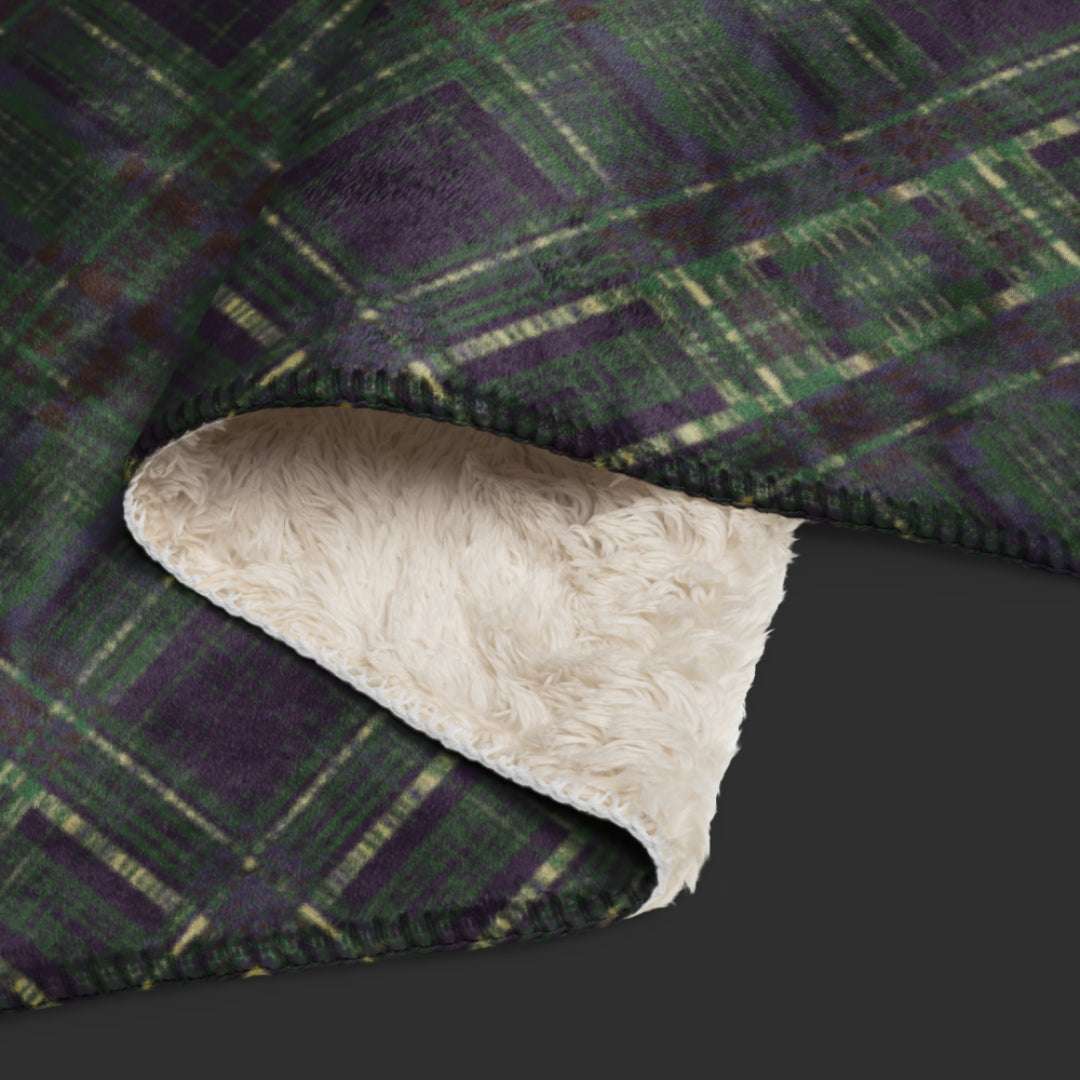 A large fleece sherpa blanket with a distressed plaid pattern in forest witchy shades