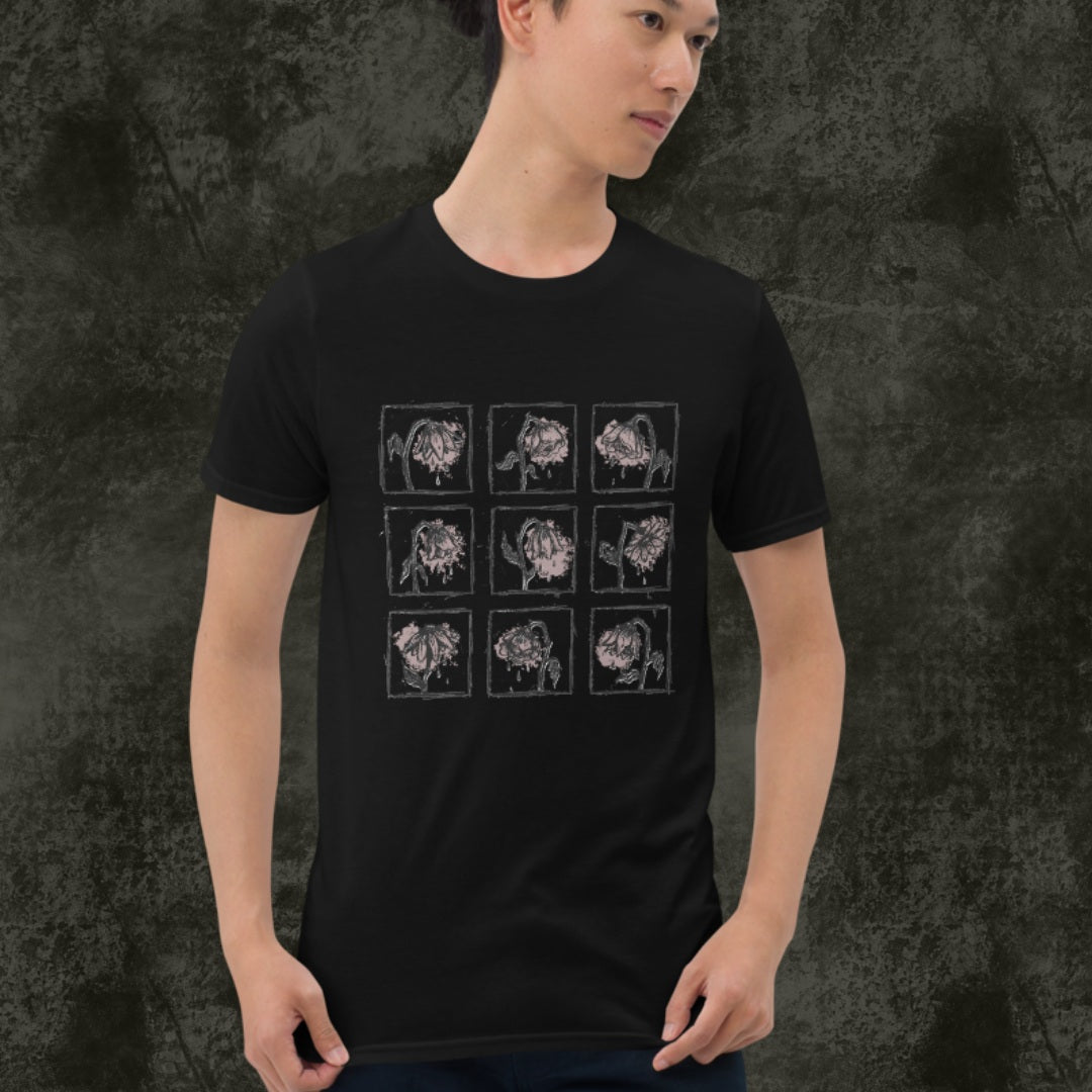 Person wearing a black gildan 64000 tee with a grid of sad crying flowers in soft pink