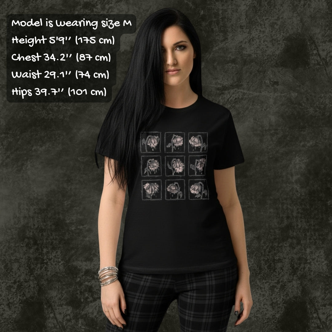 Person wearing a black Gildan 64000L tee with a grid of crying wilting flowers with soft pink details with sizing info