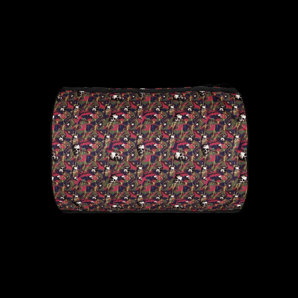 a duffel gym bag with a camo, paint splatter, and gritty skulls pattern in pink and purple shades