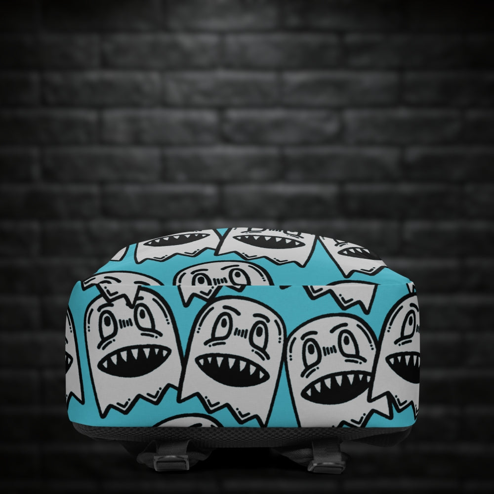 A backpack with large grey grinning goblins on skye blue background