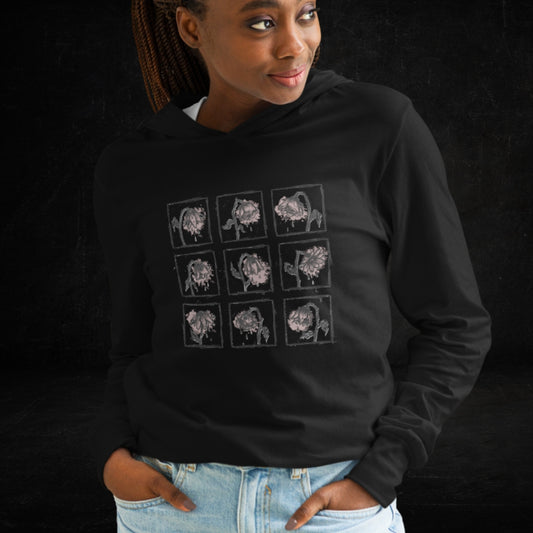 Person wearing a black bella canvas hooded long sleeve tee with a grid of wilting emo flowers