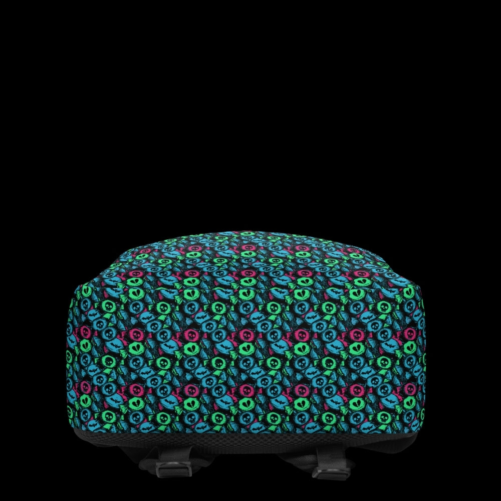 a backpack with an alt emo skull candy pattern in teal pink and green