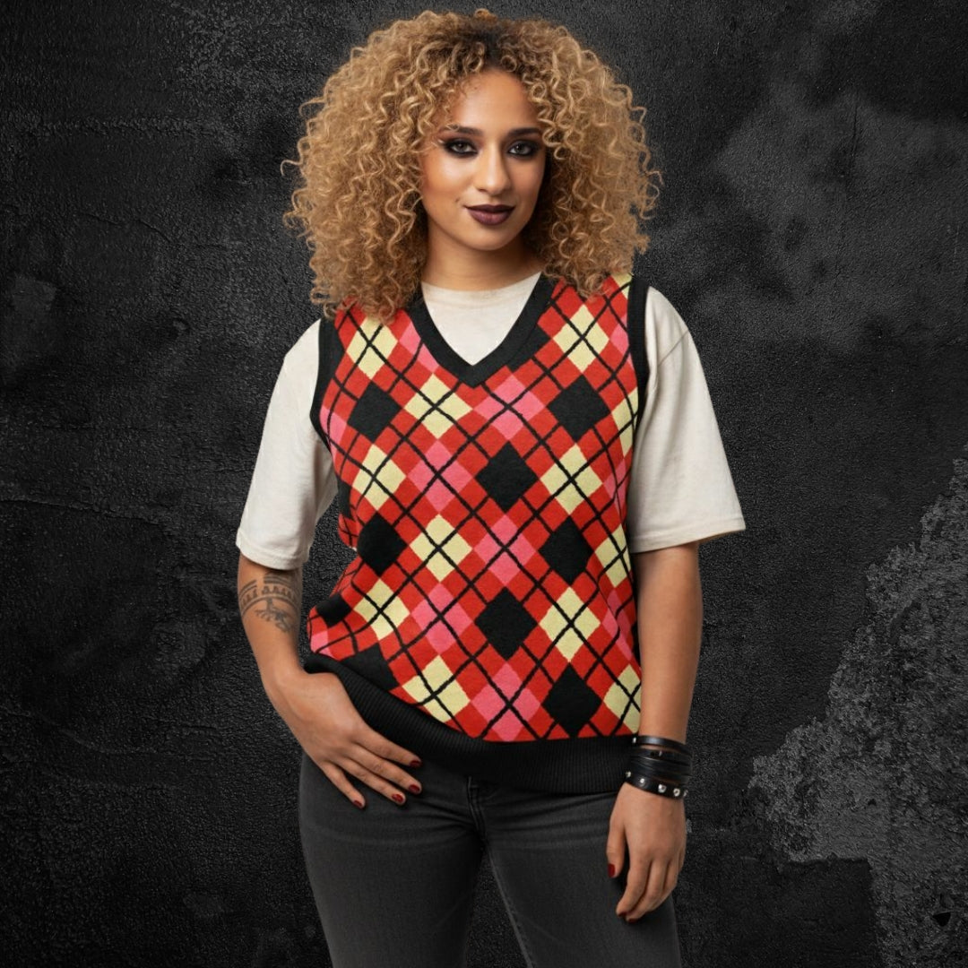 Cool alt person wearing a red and black argyle knitted vest over a white shirt on a dark background