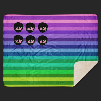 A rainbow colored sherpa blanket featuring skulls and stripes in the format on the American flag