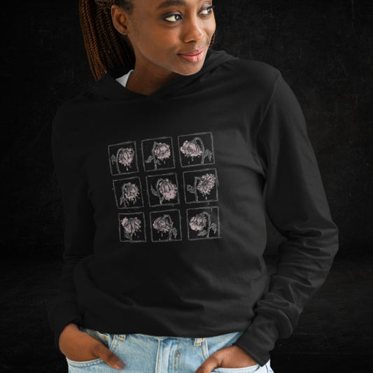 Person wearing a black Hooded Long-Sleeve Bella Canvas 3512 tee with a grid of crying emo flowers in soft pink