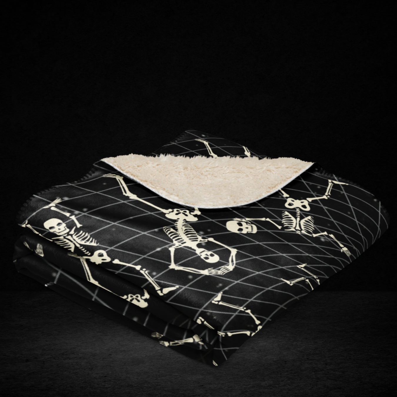 A large sherpa blanket with a vortex grid with skeletons clinging to it, falling and jumping into the void