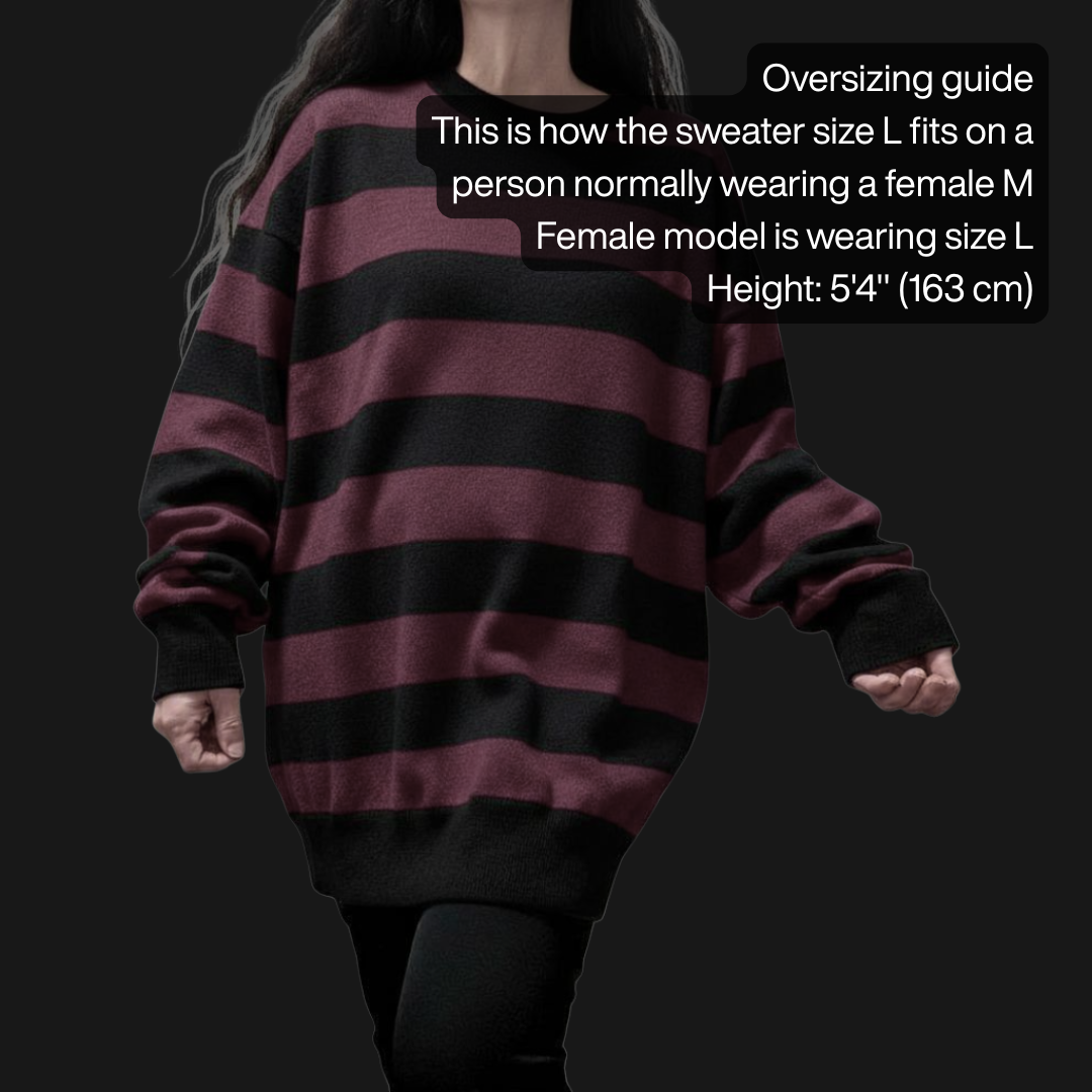Person wearing an oversized grunge striped sweater with wide black and burgundy stripes