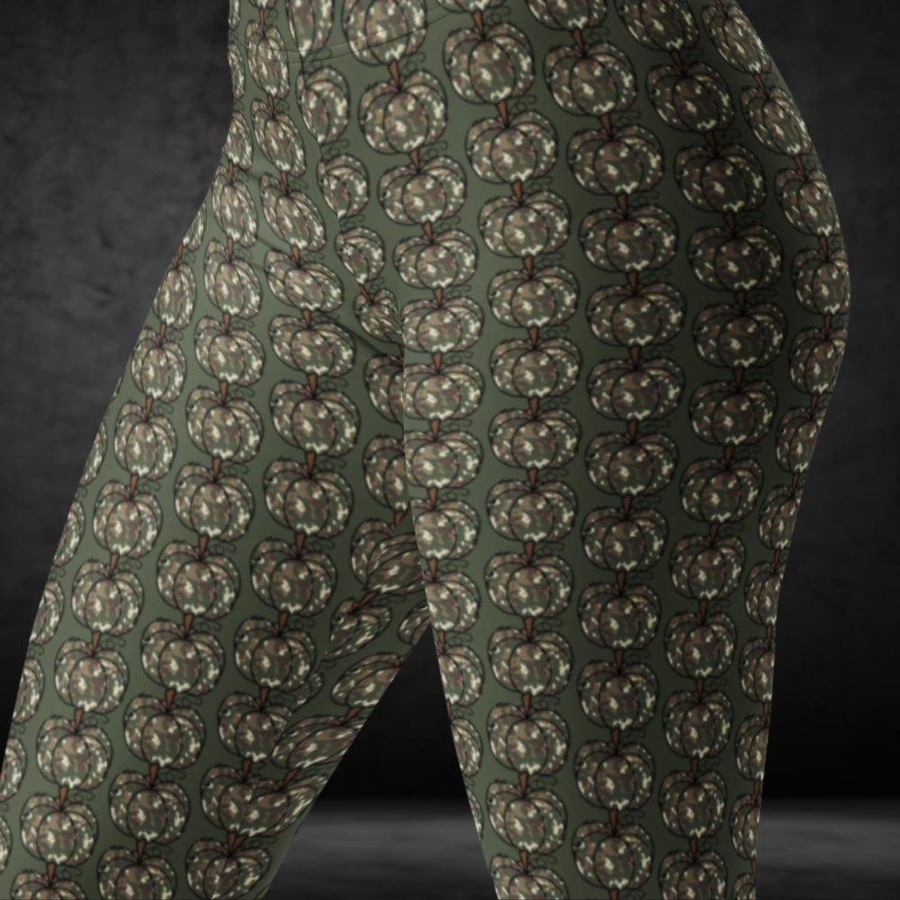 leggings with camouflage colored pumpkins on green  background