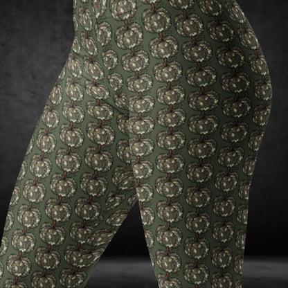 leggings with camouflage colored pumpkins on green  background